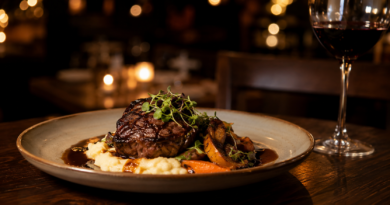 Perfectly grilled steak served with creamy mashed potatoes, roasted vegetables, and a glass of red wine in a cozy fine dining restaurant.