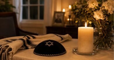 Jewish Shiva memorial with candle, tallit, and flowers